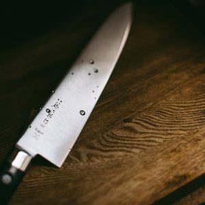 gray knife on brown wooden surface